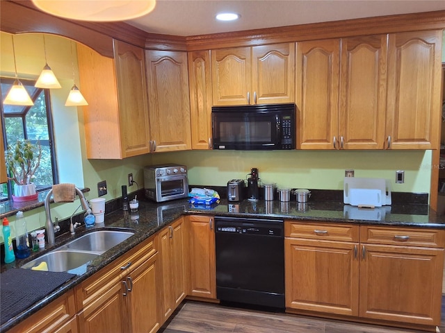 29205 Old Ml E, Tavares, FL 32778 - kitchen with black appliances, dark stone counters, pendant lighting, dark wood-style flooring, and brown cabinets