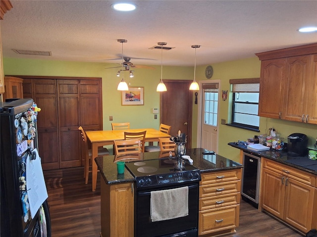 29205 Old Ml E, Tavares, FL 32778 - kitchen featuring black range with electric stovetop, dark wood finished floors, wine cooler, ceiling fan, and a center island