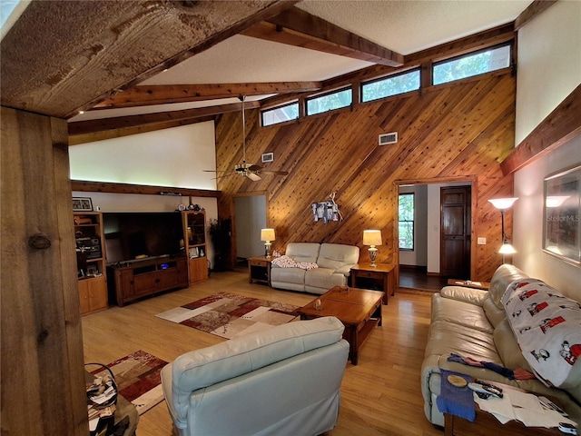 29205 Old Ml E, Tavares, FL 32778 - living area with wood walls, high vaulted ceiling, light wood finished floors, and beam ceiling