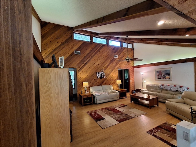 29205 Old Ml E, Tavares, FL 32778 - living room featuring wooden walls, high vaulted ceiling, beamed ceiling, and light wood-type flooring