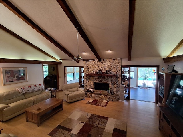 29205 Old Ml E, Tavares, FL 32778 - living area featuring a ceiling fan, light wood-type flooring, and a stone fireplace
