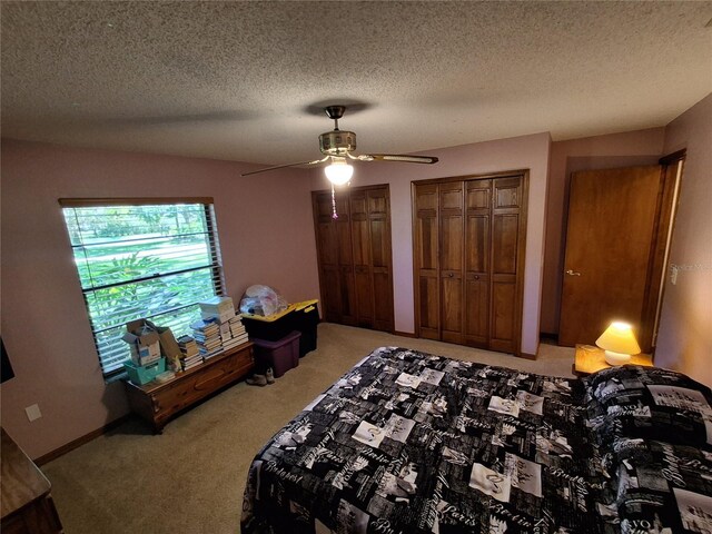 29205 Old Ml E, Tavares, FL 32778 - bedroom with light colored carpet, multiple closets, a textured ceiling, and ceiling fan