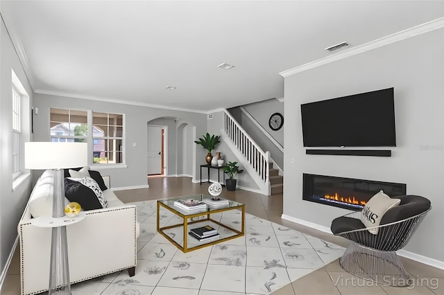 15604 Starlite St, Clermont, FL 34714 - tiled living area featuring crown molding, arched walkways, stairway, and a glass covered fireplace