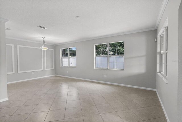 15604 Starlite St, Clermont, FL 34714 - empty room featuring crown molding, tile patterned floors, and a textured ceiling