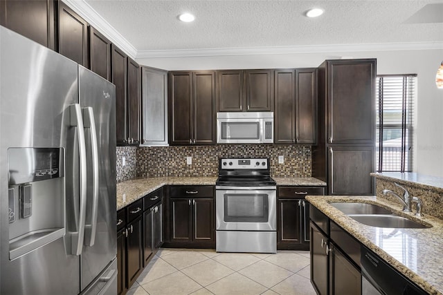 15604 Starlite St, Clermont, FL 34714 - kitchen featuring appliances with stainless steel finishes, crown molding, a textured ceiling, tasteful backsplash, and light tile patterned floors