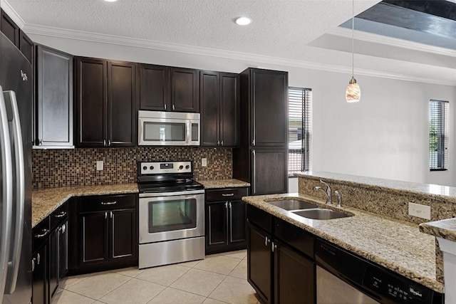 15604 Starlite St, Clermont, FL 34714 - kitchen with stainless steel appliances, healthy amount of natural light, backsplash, light tile patterned floors, and ornamental molding