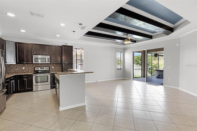 15604 Starlite St, Clermont, FL 34714 - kitchen with stainless steel appliances, ceiling fan, ornamental molding, light tile patterned floors, and open floor plan