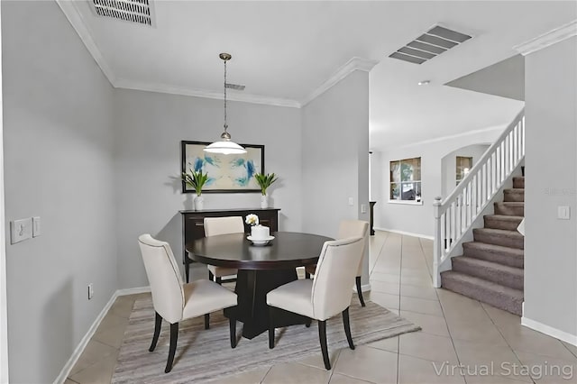 15604 Starlite St, Clermont, FL 34714 - dining area with light tile patterned flooring, ornamental molding, and stairs