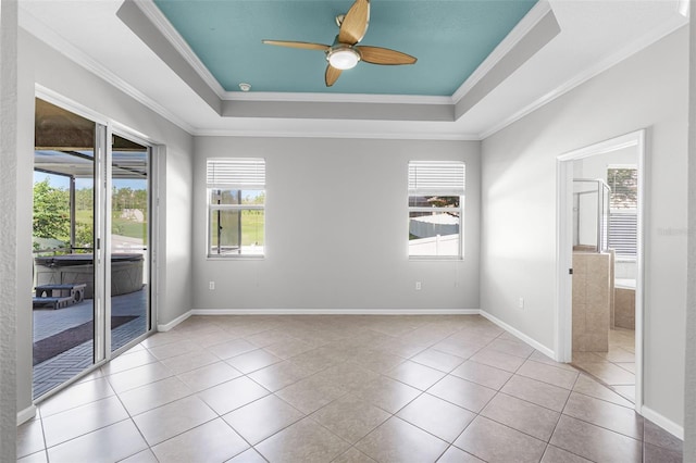 15604 Starlite St, Clermont, FL 34714 - spare room with healthy amount of natural light, a raised ceiling, ornamental molding, ceiling fan, and tile patterned flooring