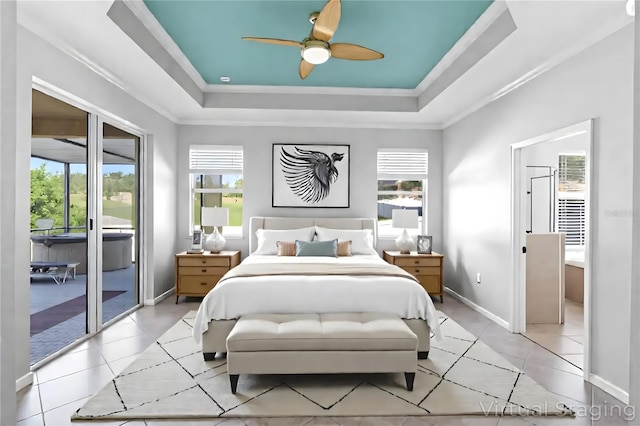 15604 Starlite St, Clermont, FL 34714 - bedroom featuring access to exterior, multiple windows, a tray ceiling, and ornamental molding