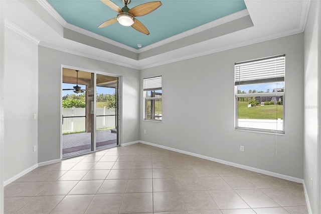 15604 Starlite St, Clermont, FL 34714 - empty room with a ceiling fan, a tray ceiling, crown molding, and light tile patterned floors