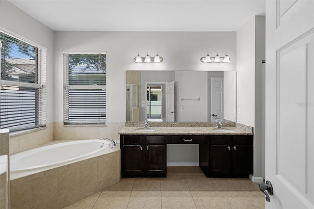 15604 Starlite St, Clermont, FL 34714 - bathroom featuring a bath, a shower stall, double vanity, and tile patterned flooring