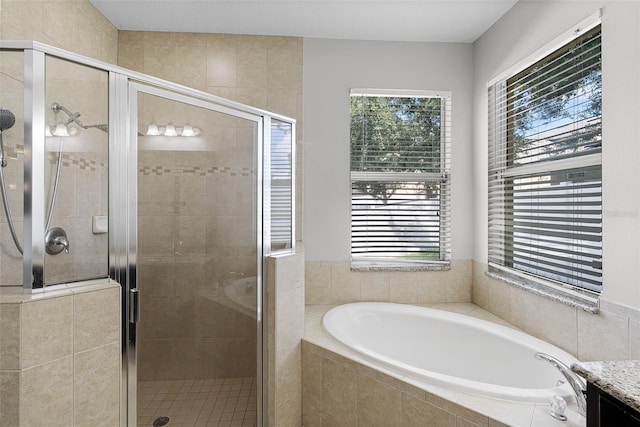 15604 Starlite St, Clermont, FL 34714 - full bathroom featuring a garden tub, healthy amount of natural light, a stall shower, and vanity
