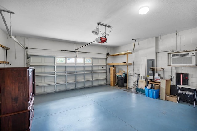 15604 Starlite St, Clermont, FL 34714 - garage featuring a garage door opener, a wall mounted AC, electric panel, and concrete block wall