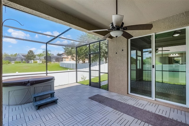 15604 Starlite St, Clermont, FL 34714 - unfurnished sunroom featuring a hot tub, ceiling fan, and a residential view