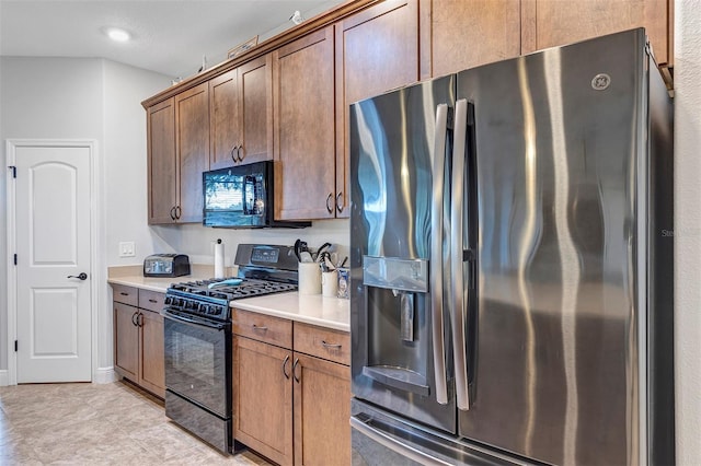 3681 Arlington Ridge Blvd, Leesburg, FL 34748 - kitchen with black appliances, light countertops, and light tile patterned flooring