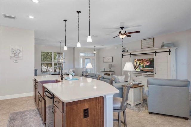 3681 Arlington Ridge Blvd, Leesburg, FL 34748 - kitchen with open floor plan, light countertops, ceiling fan, an island with sink, and a barn door