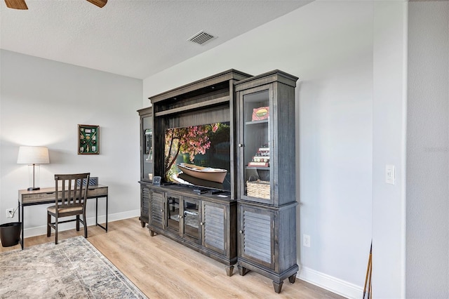 3681 Arlington Ridge Blvd, Leesburg, FL 34748 - living room featuring light wood-style flooring, ceiling fan, and a textured ceiling