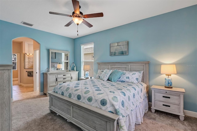 3681 Arlington Ridge Blvd, Leesburg, FL 34748 - bedroom featuring arched walkways, carpet, a ceiling fan, and ensuite bathroom