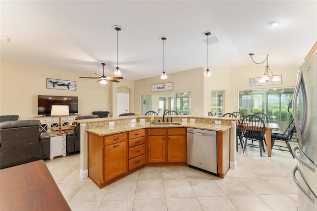 3750 Raspberry Ct, The Villages, FL 32163 - kitchen featuring appliances with stainless steel finishes, open floor plan, plenty of natural light, decorative light fixtures, and vaulted ceiling