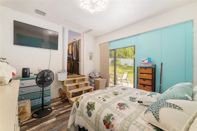 149 Shiloh Ave, Lady Lake, FL 32159 - bedroom featuring freestanding refrigerator, dark wood finished floors, and access to exterior