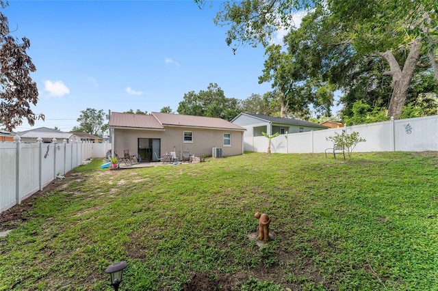149 Shiloh Ave, Lady Lake, FL 32159 - back of house featuring a patio area, a fenced backyard, stucco siding, and a metal roof