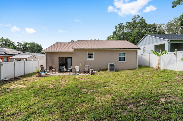 149 Shiloh Ave, Lady Lake, FL 32159 - back of house featuring stucco siding, a fenced backyard, a patio, and a metal roof