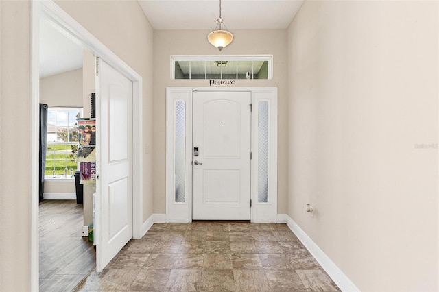 7732 Sloewood Dr, Leesburg, FL 34748 - entryway with baseboards and light stone finish flooring