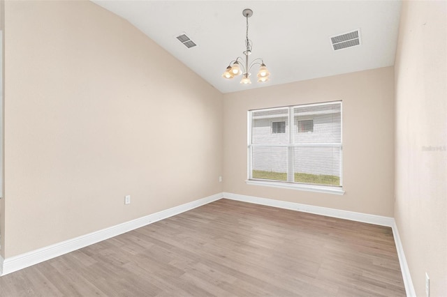 7732 Sloewood Dr, Leesburg, FL 34748 - empty room with a chandelier, lofted ceiling, and light wood-type flooring