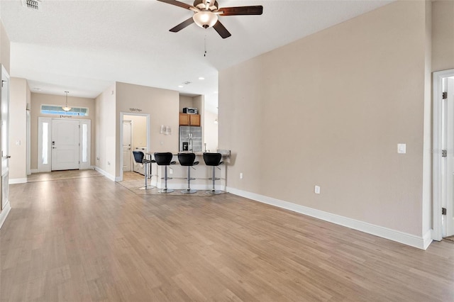 7732 Sloewood Dr, Leesburg, FL 34748 - living area with a ceiling fan and light wood-style floors