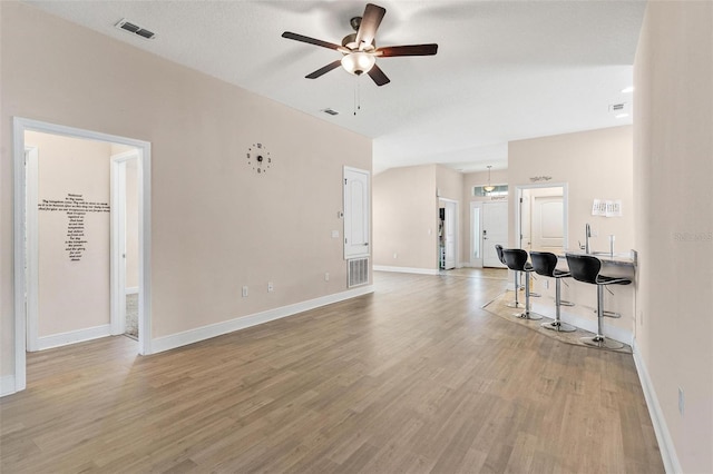 7732 Sloewood Dr, Leesburg, FL 34748 - unfurnished living room with ceiling fan and light wood-style flooring