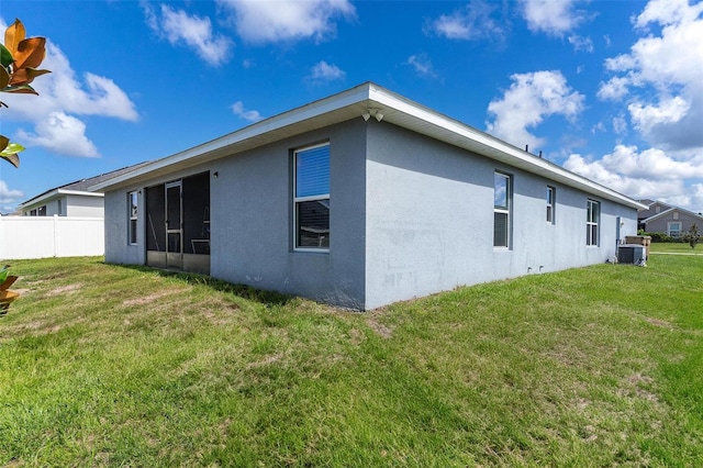 7732 Sloewood Dr, Leesburg, FL 34748 - rear view of property featuring stucco siding and a sunroom