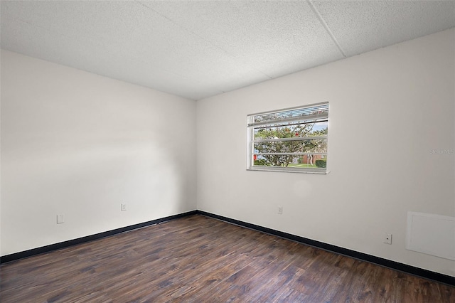 600 W Oak Terrace Dr, Leesburg, FL 34748 - spare room featuring dark wood-style floors and baseboards