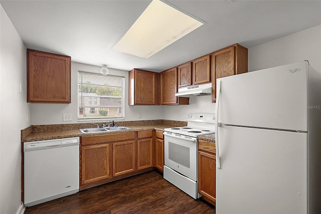 600 W Oak Terrace Dr, Leesburg, FL 34748 - kitchen featuring white appliances, under cabinet range hood, dark wood-style flooring, and brown cabinetry