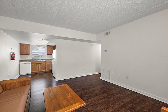 600 W Oak Terrace Dr, Leesburg, FL 34748 - unfurnished living room featuring dark wood-style floors and a textured ceiling