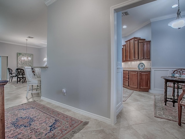 1982 Eldridge Loop, The Villages, FL 32162 - corridor with ornamental molding, a chandelier, and light tile patterned flooring