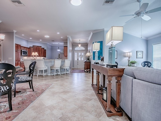 1982 Eldridge Loop, The Villages, FL 32162 - living area featuring a ceiling fan, healthy amount of natural light, crown molding, and recessed lighting