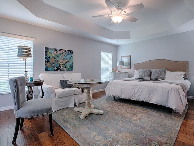 1982 Eldridge Loop, The Villages, FL 32162 - bedroom with a raised ceiling, wood finished floors, and ceiling fan