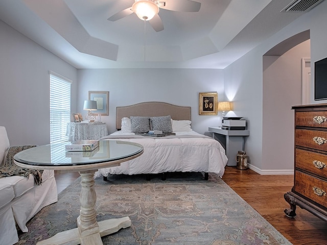 1982 Eldridge Loop, The Villages, FL 32162 - bedroom with a tray ceiling, wood finished floors, and ceiling fan