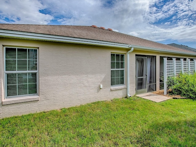 1982 Eldridge Loop, The Villages, FL 32162 - rear view of property featuring a lawn and stucco siding