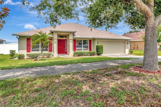 1216 Cheshire St, Groveland, FL 34736 - ranch-style home with stucco siding, an attached garage, and concrete driveway