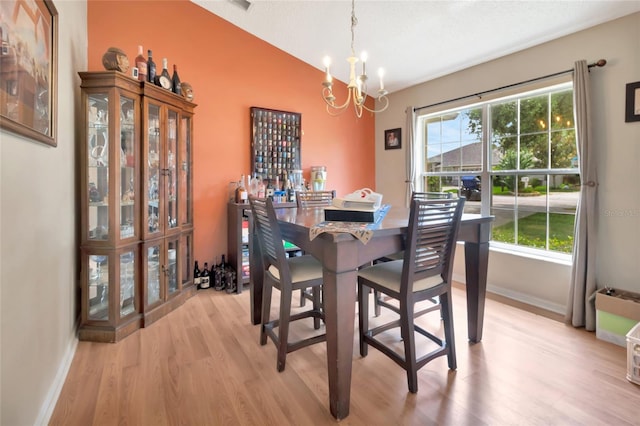 1216 Cheshire St, Groveland, FL 34736 - dining room featuring a chandelier, light wood-type flooring, and lofted ceiling