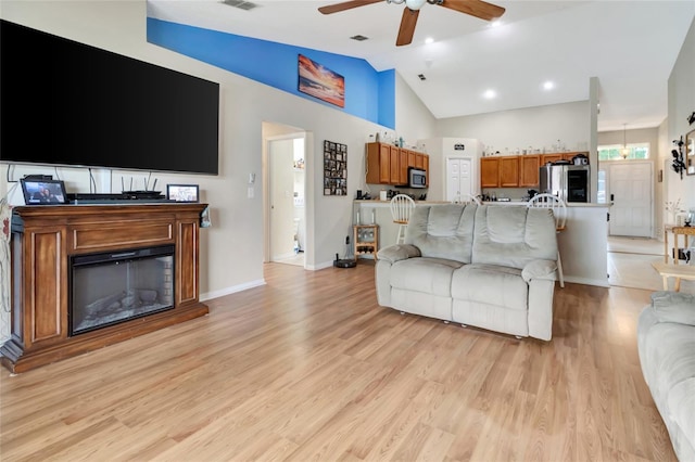 1216 Cheshire St, Groveland, FL 34736 - living room with a ceiling fan, light wood finished floors, and lofted ceiling