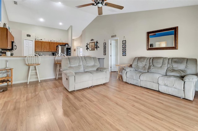 1216 Cheshire St, Groveland, FL 34736 - living room featuring a ceiling fan, light wood-style flooring, and high vaulted ceiling