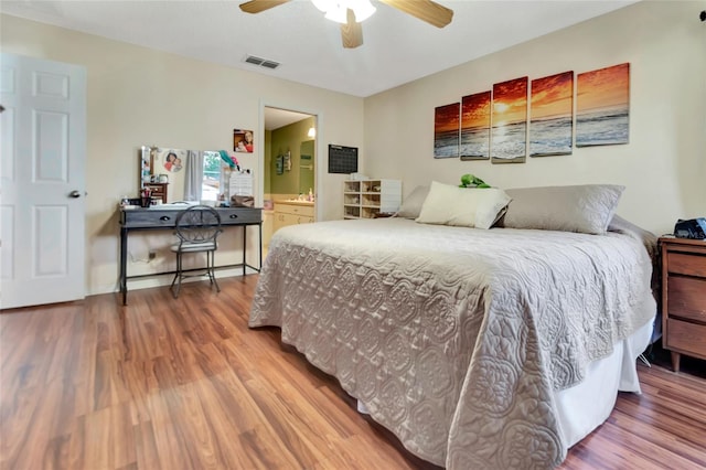 1216 Cheshire St, Groveland, FL 34736 - bedroom featuring wood finished floors, ensuite bath, and freestanding refrigerator