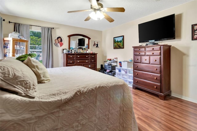 1216 Cheshire St, Groveland, FL 34736 - bedroom with wood finished floors, a textured ceiling, ceiling fan, and arched walkways