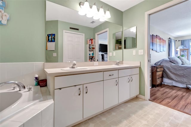 1216 Cheshire St, Groveland, FL 34736 - bathroom with ensuite bath, double vanity, and a garden tub