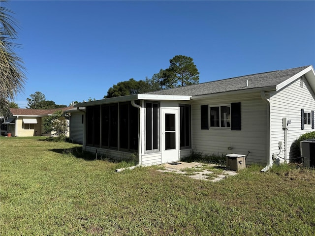 8344 SW 107th Pl, Ocala, FL 34481 - back of property with a sunroom, a yard, and roof with shingles