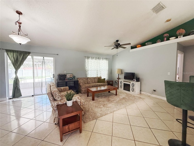 15349 Lafite Ln, Clermont, FL 34714 - living area with light tile patterned floors, healthy amount of natural light, ceiling fan, lofted ceiling, and a textured ceiling