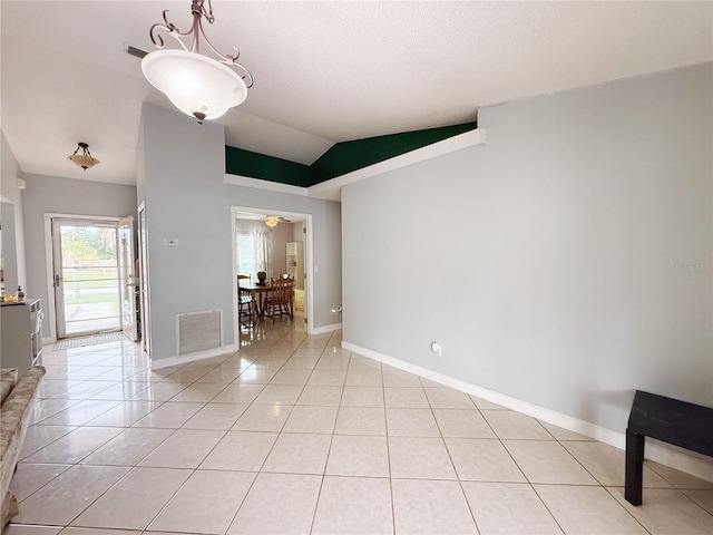 15349 Lafite Ln, Clermont, FL 34714 - empty room featuring light tile patterned flooring and lofted ceiling